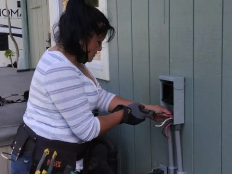 Licensed electrician wiring an exterior subpanel in Mashpee